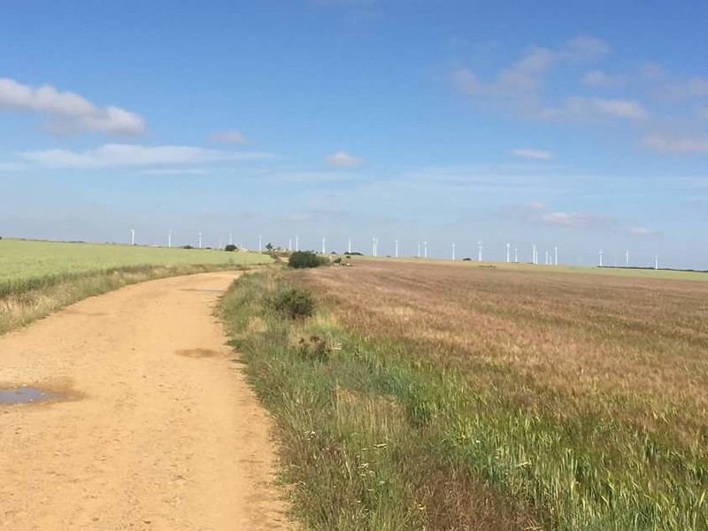 Flat roads with wind turbines in the distance