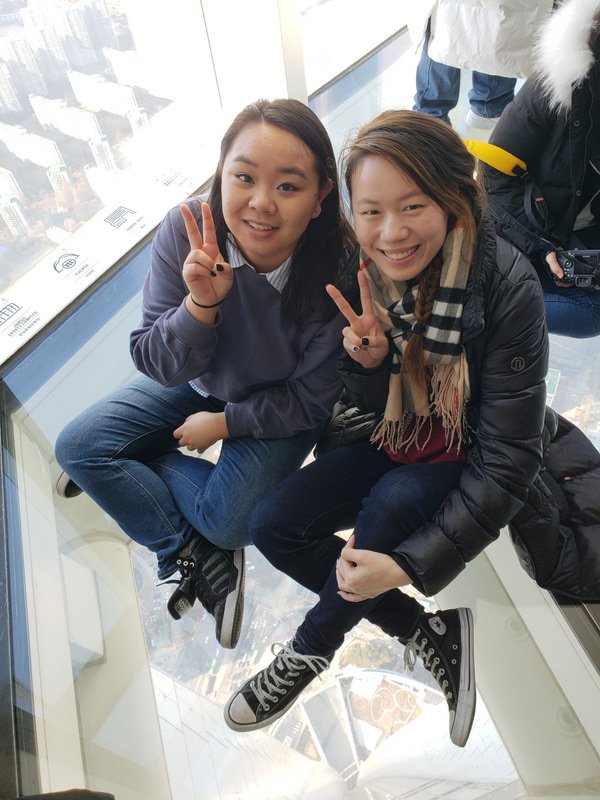 Natanya and l sitting on the Lotte Tower Skywalk