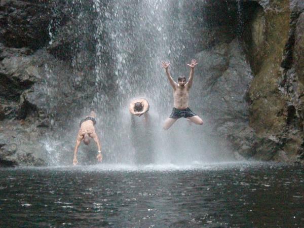 Rod (middle) and friends jumping thru waterfall
