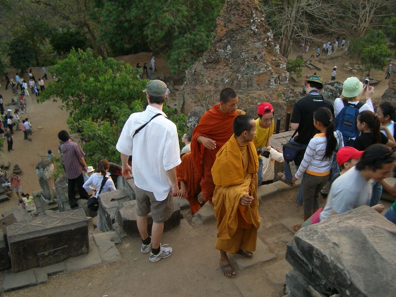 Monks in traditional garb join the tourists