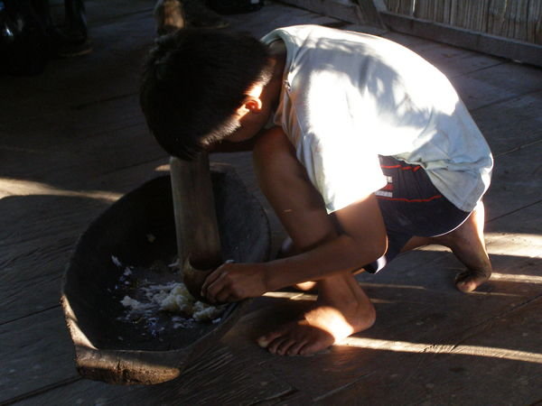 Kichwa child preparing the local alcohol