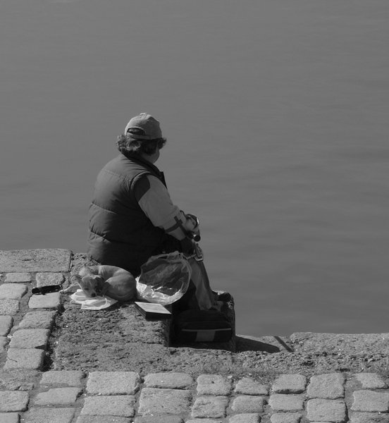 Fisherman and his friend by the canal