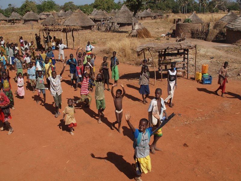 Village children waving goodbye
