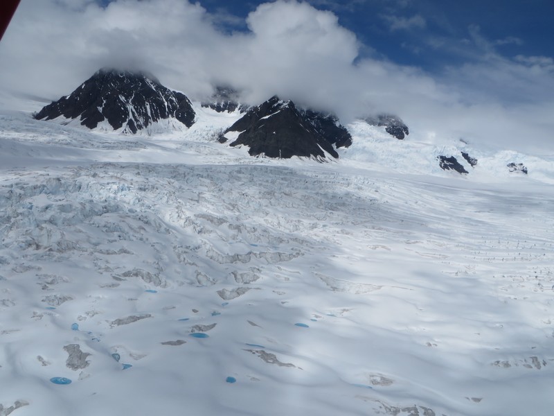 Teal/blue puddles on glacier