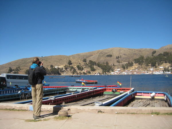 standing on the shore of Lake Titicaca