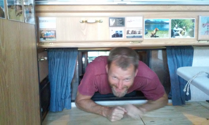 Ken trying to squeeze from the truck into the camper