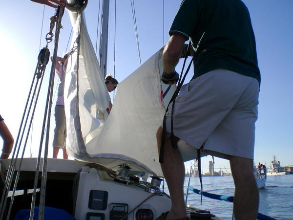 Crew Putting up the Sail on My boat