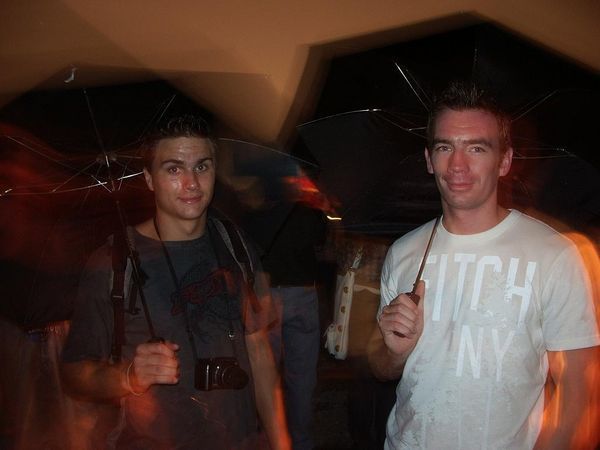 Chris and Rob enjoying a rainy 4th of July Fireworks display under their umbrellas