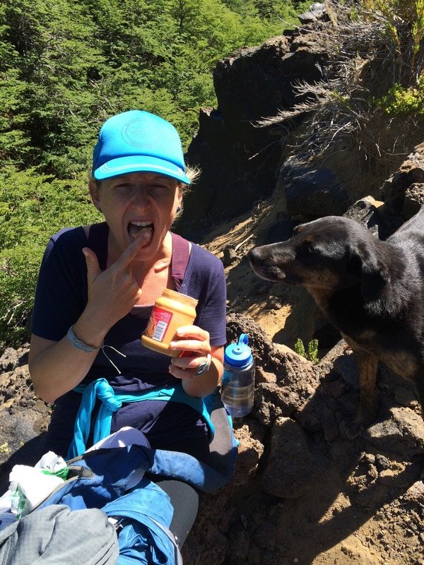 A hikers lunch...peanut butter and no spoon.  A salivating dog watches closely.