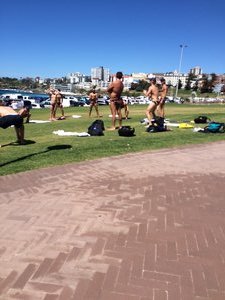Just guys in speedos stretching at Bondi beach.