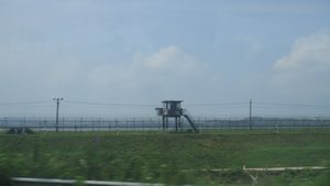 Barbed wire fence and guard tower