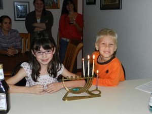 Luna and Tavi lighting the Menorah