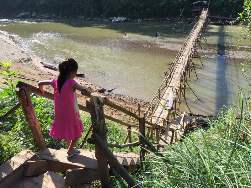 Girl crossing the bamboo bridge