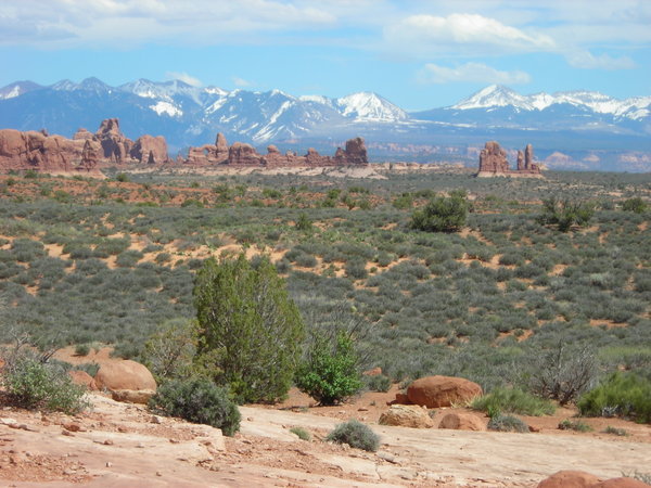 The picturesque landscape of Arches with the La Sals in the distance (Turret Arch can be seen a little left of center)