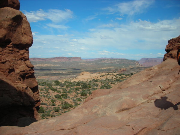The arid desert, mesas, and canyons to the east of the park, as seen through the North Window