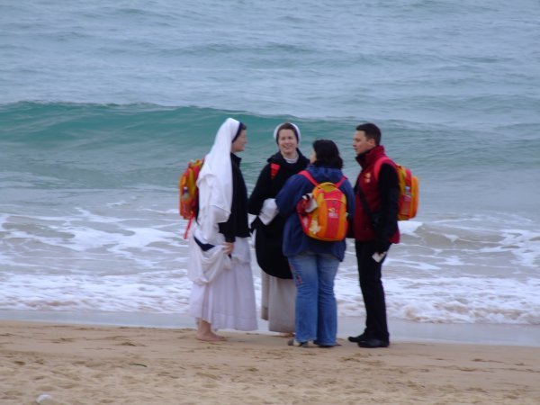 Modern Nun's barefoot on the beach at Manly