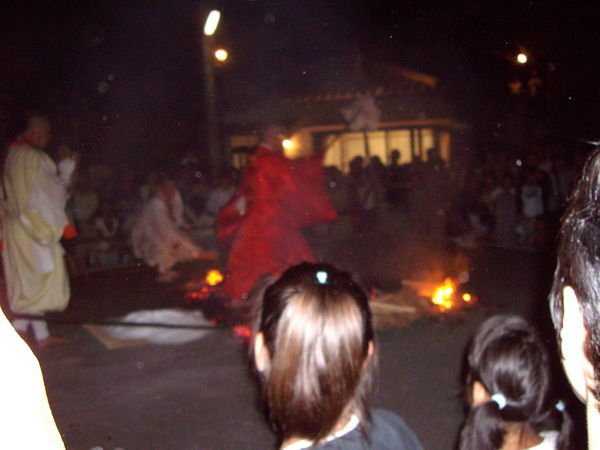 Fire walking begins, the held priest or someone important