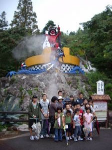 Red Demon standing on an enormous cooking pot, big Japanese family