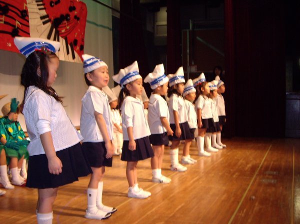 A group singing "A sailor went to sea"