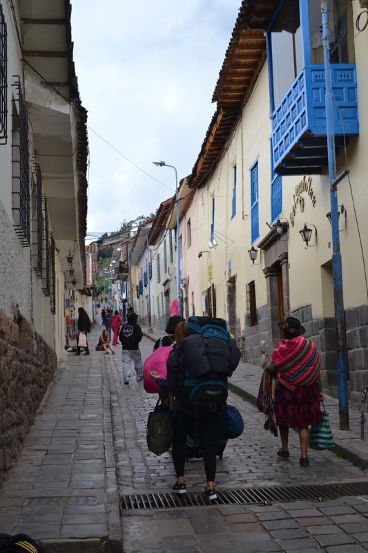 Backpackers and Inca ladys wander the streets together