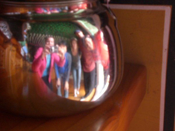 Group shot through a tea kettle