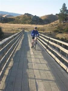Carol biking on the Otago Railtrail Trestle
