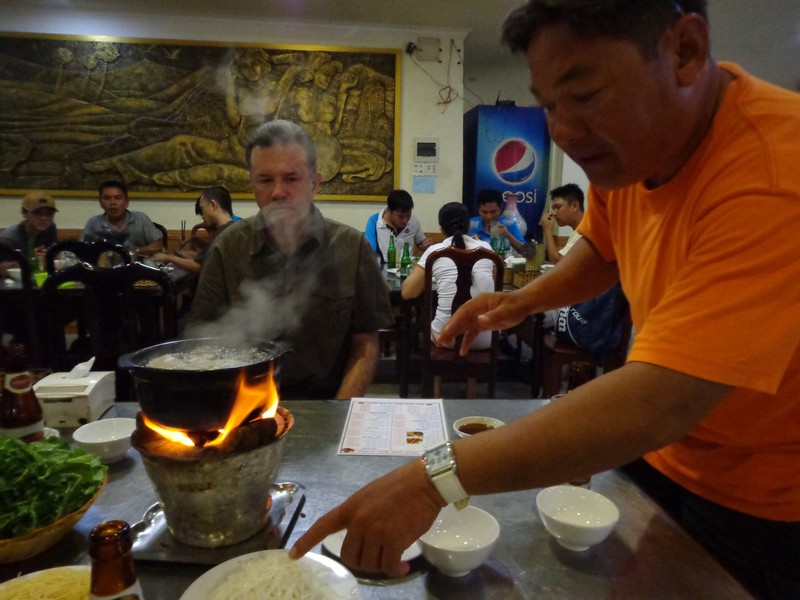 Cycling Guide Showing Vitnamese Hotpot Cooking after a day of Cycling