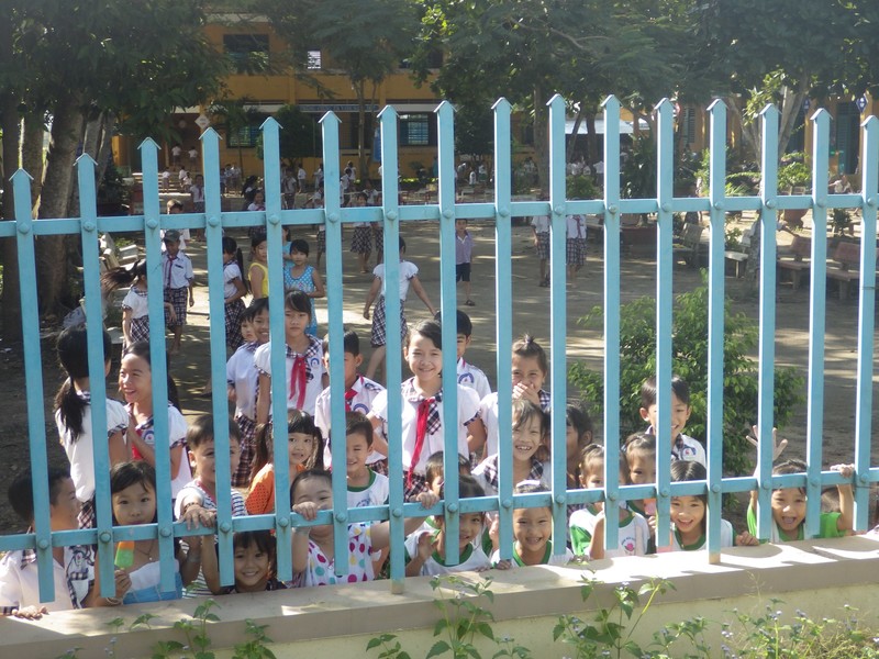 "Hellow!" Kids through the school fence