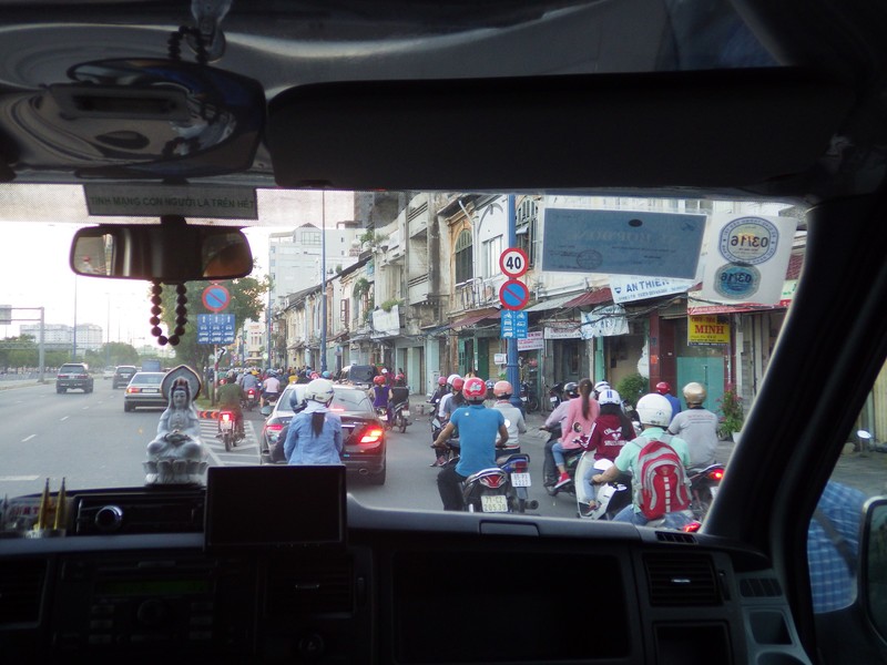 Buddha Telling Driver Carfull of Scooter Traffic when merging in Saigon Rush Hour Seperate Scooter Lane Right
