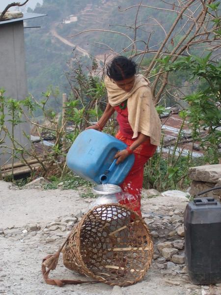 Woman getting water on mountain