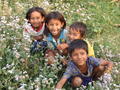Children from Tharu village posing in flowers