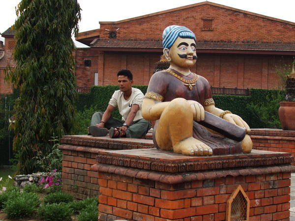 Nepali man by Hindu statue