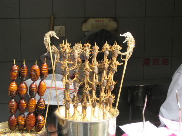Yes, that is scorpion, sea horse & worm on a stick