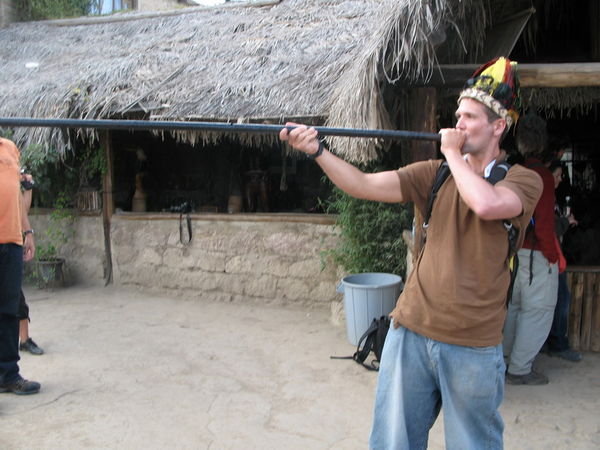 Dave aiming a blow pipe at Mitad del Mundo (the equator)