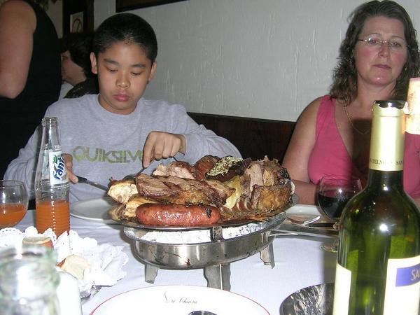 Jose and Siri eating their plate of meat
