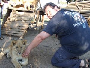 Jase petting a lion cub