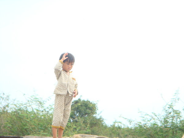 Boy waving us goodbye from Kompong Luong
