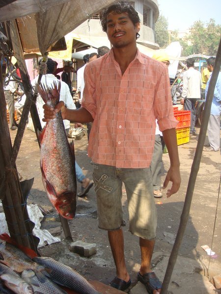 Fishmonger posing with a fish