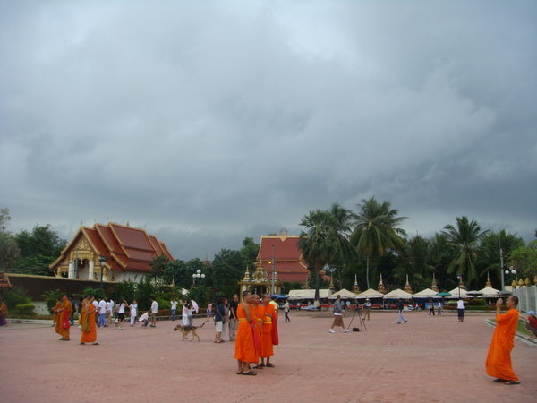 Monks getting their photo taken - Pha That Luang