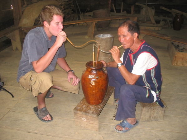 Having some rice wine with the village chief