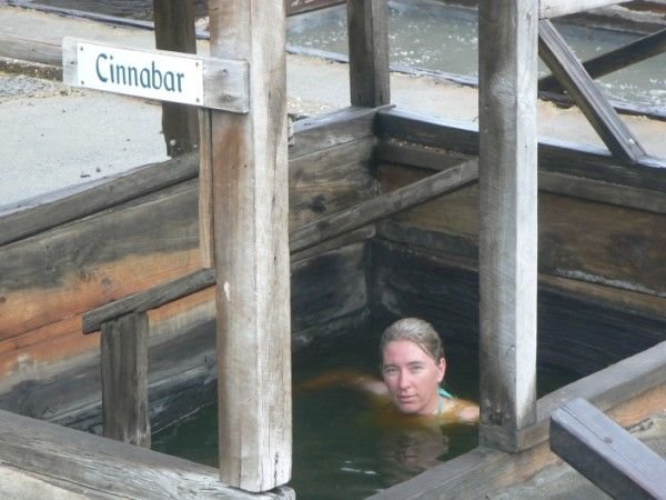 Karen soaking in the green tinged waters of the Cinnabar pool