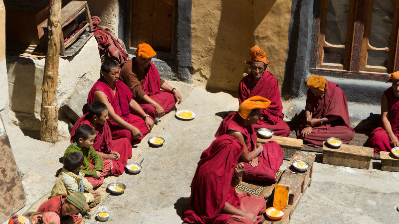 Monks waiting to start their lunch