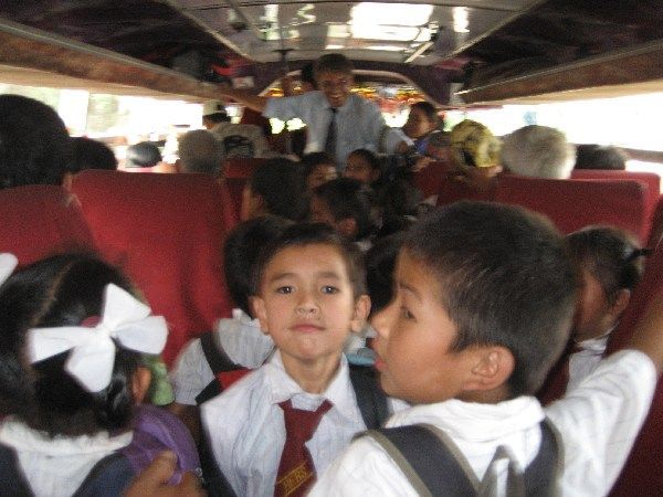 Singing school kids cram onto the bus