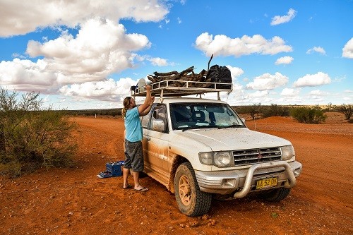 Bush mechanic in action after the roofrack had a blowout Oodnadatta Track