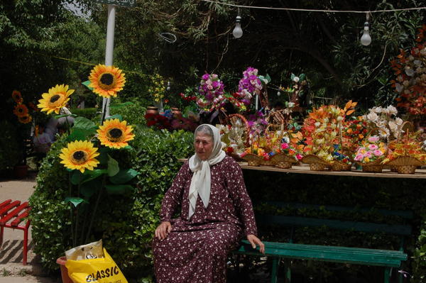 Goose lady in the flower market of Hama