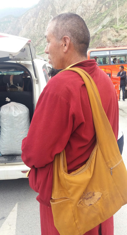 A Buddhist monk while waiting for the bus 