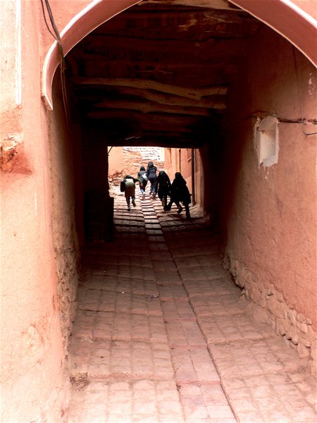 kids running off down a street in Abyaneh