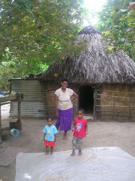 A family in Soso Village come out to say Bula!