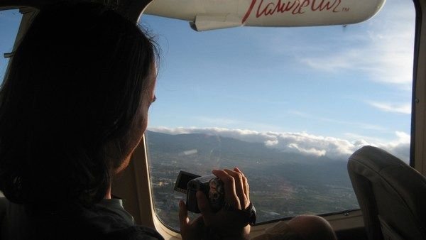A picture of a picture taker in a plane