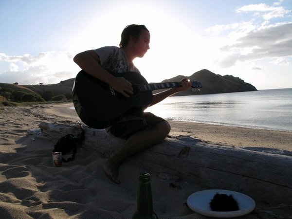Playing guitar on a remote beach is nice